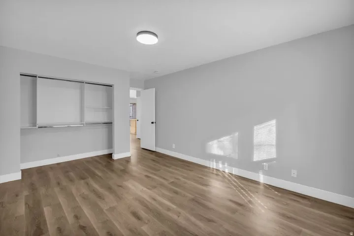 Unfurnished bedroom featuring a closet and wood finished floors