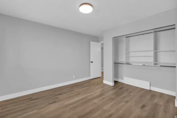 Unfurnished bedroom featuring light wood finished floors and a closet