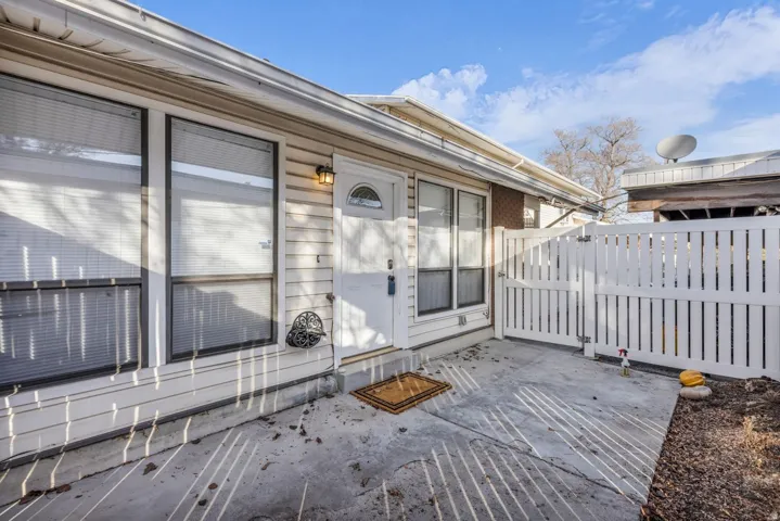Doorway to property featuring a patio area