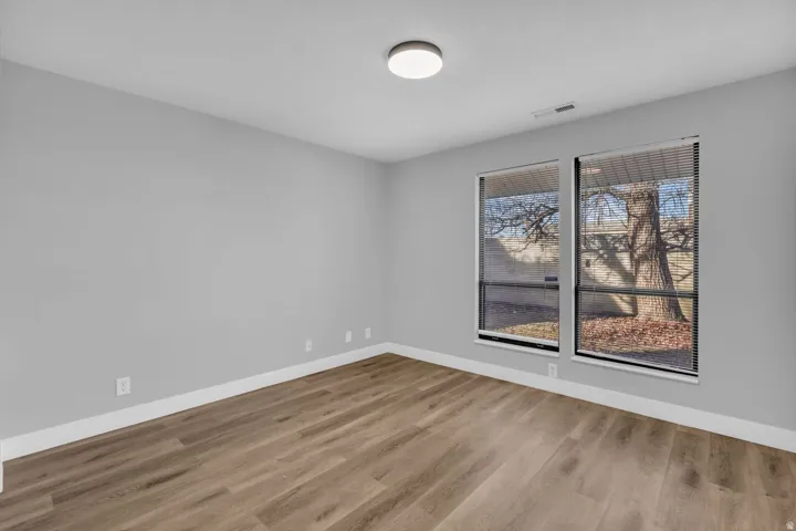 Unfurnished room with baseboards and light wood-type flooring