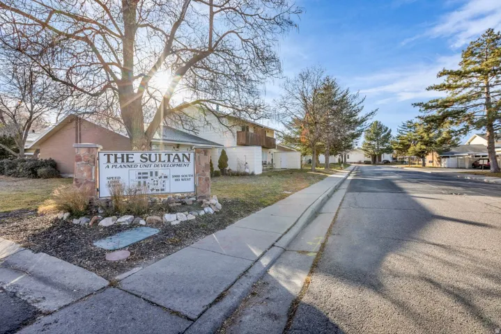 View of asphalt road with sidewalks, curbs, and a residential view
