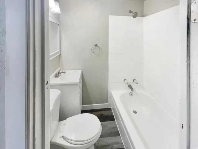 Full bathroom with white subway tile shower surround and bathtub