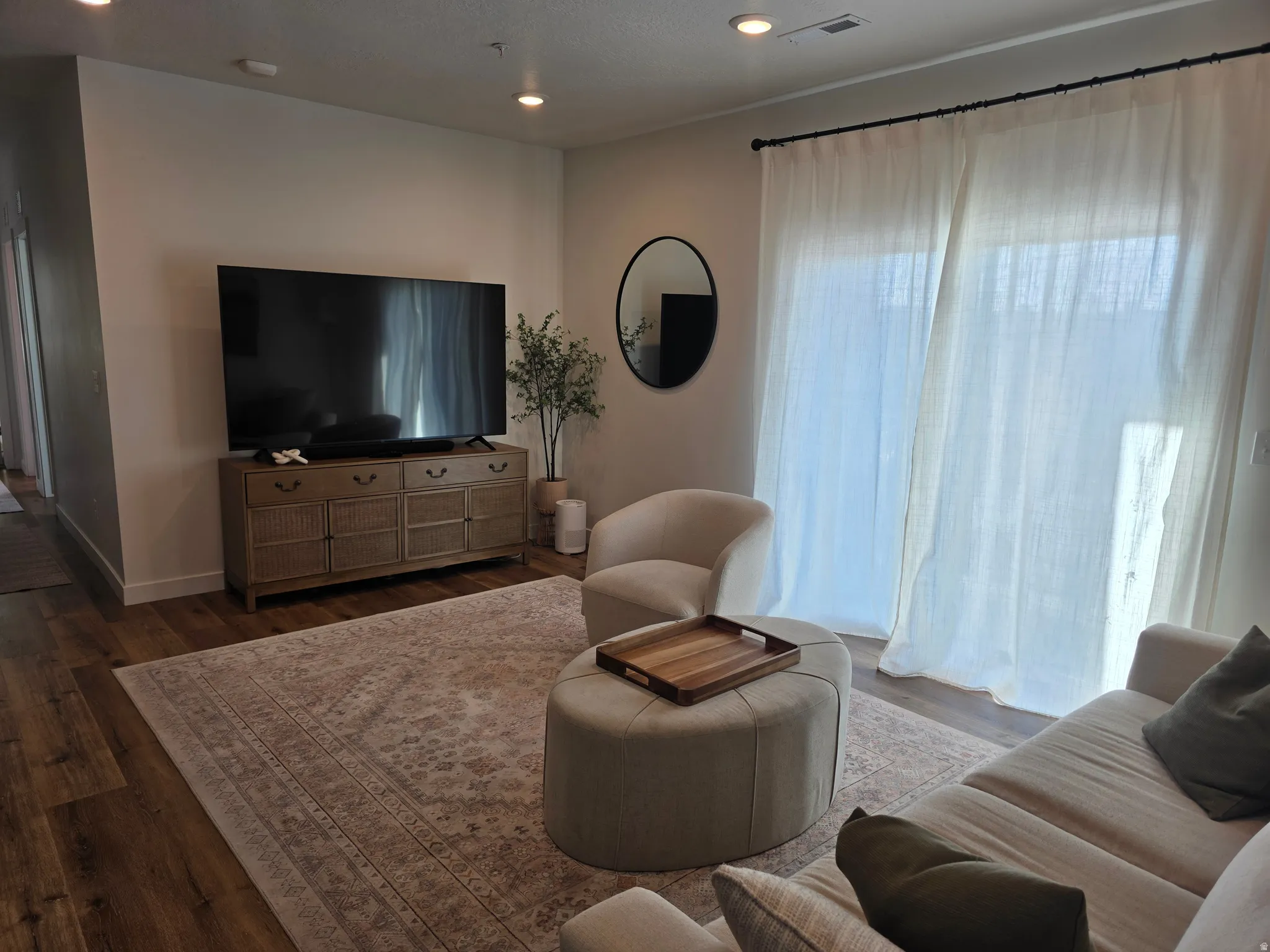 Living area featuring wood finished floors and recessed lighting