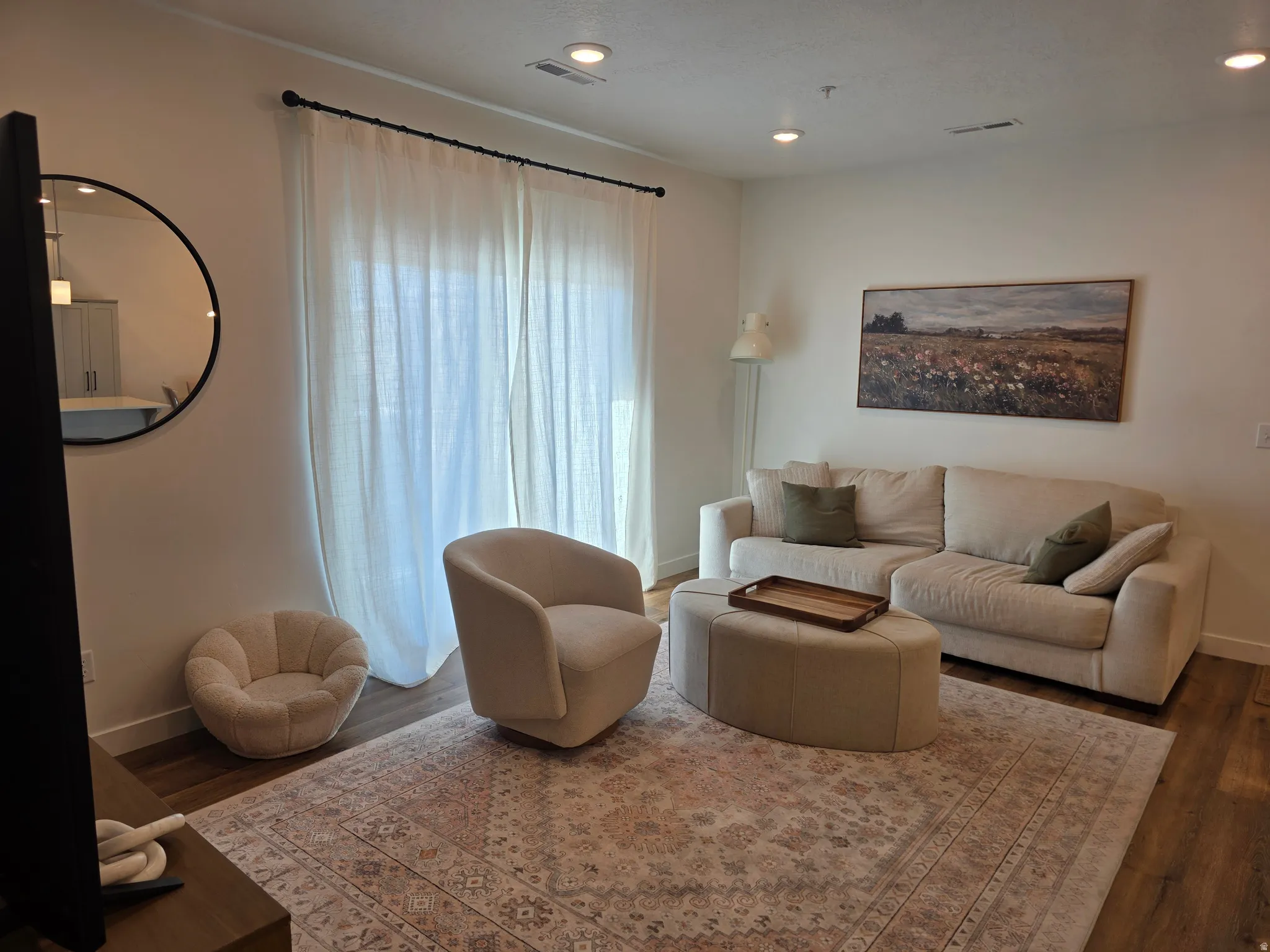 Living area with dark wood finished floors and recessed lighting