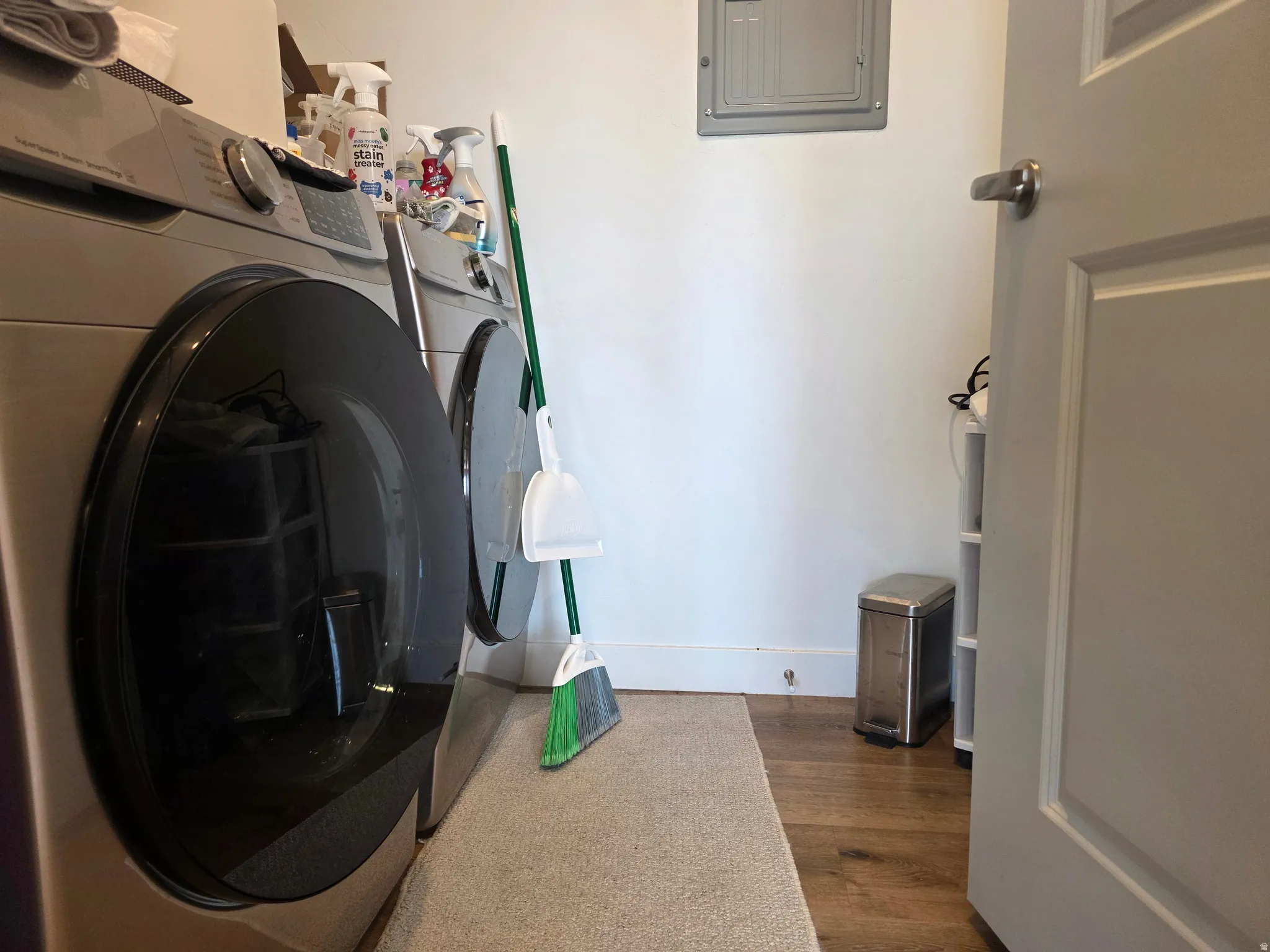 Laundry room with dark wood finished floors, electric panel (Additional storage too)