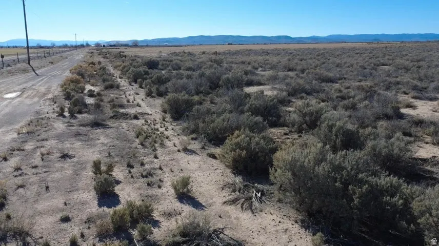Aerial view of property's location featuring rural landscape and a mountainous background