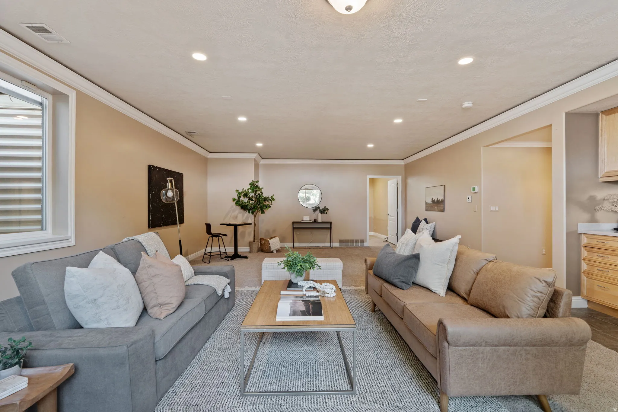 Living area featuring recessed lighting and crown molding