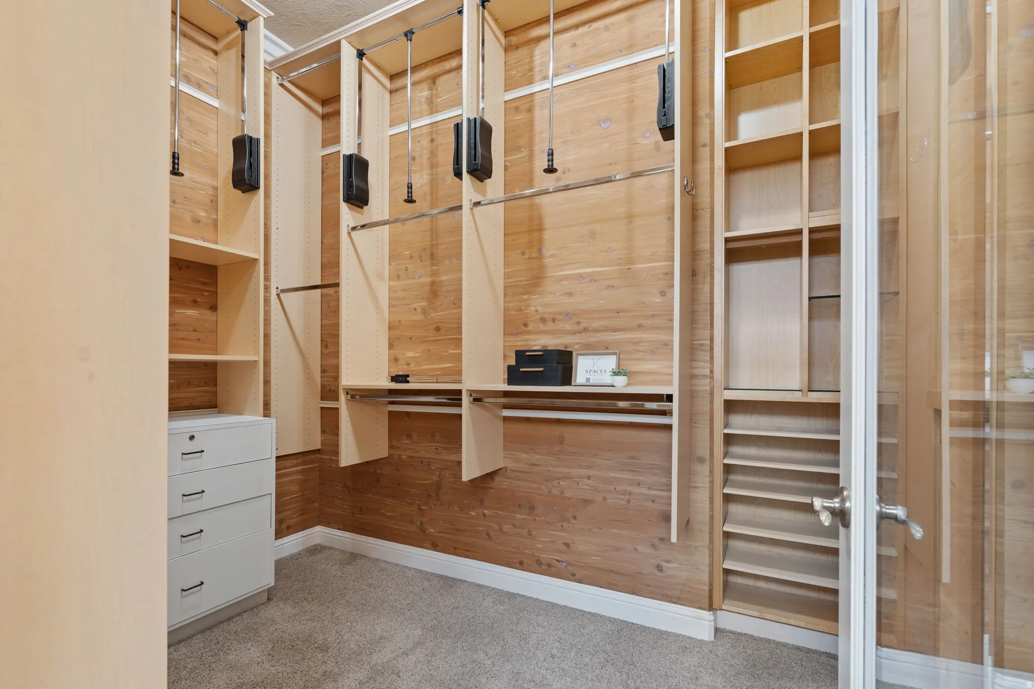 Walk in custom cedar closet with light colored carpet