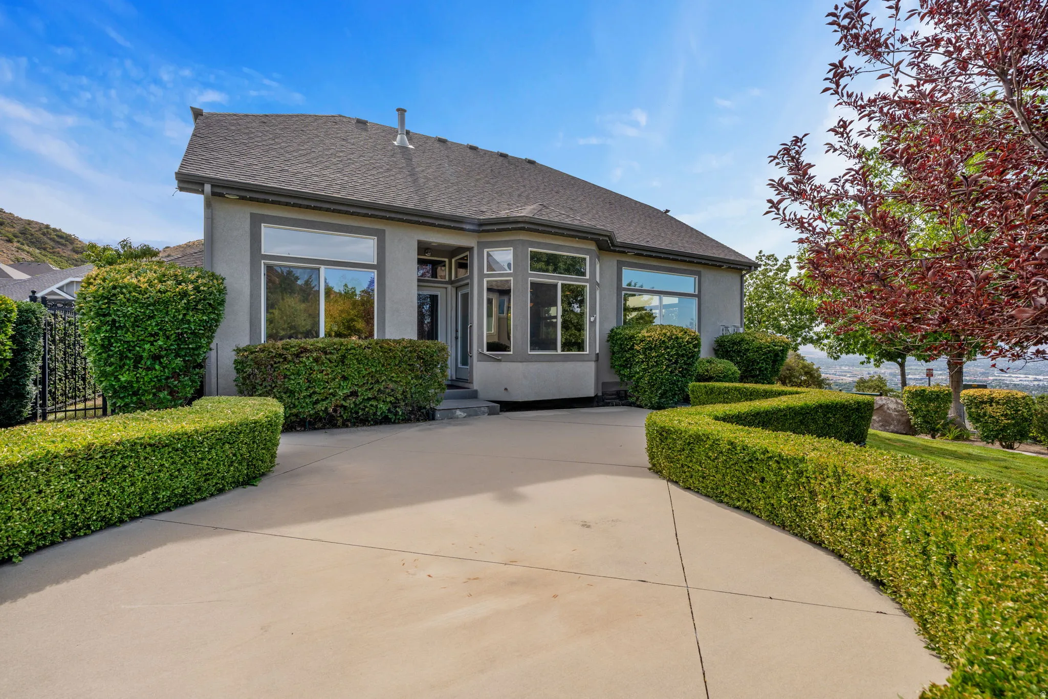 Back of property featuring stucco siding and roof with shingles