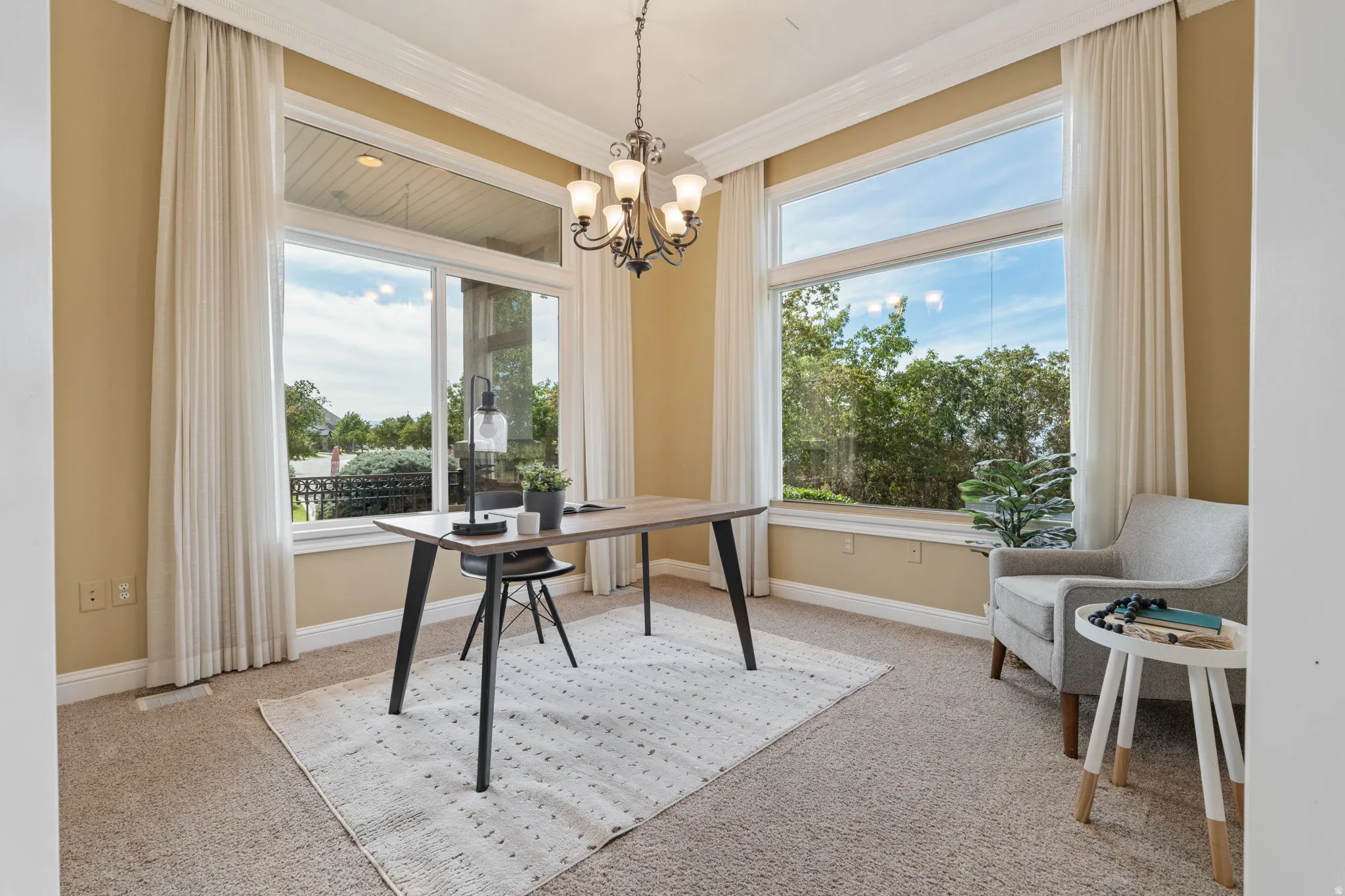 Office/Living room with a chandelier, light colored carpet, and ornamental molding