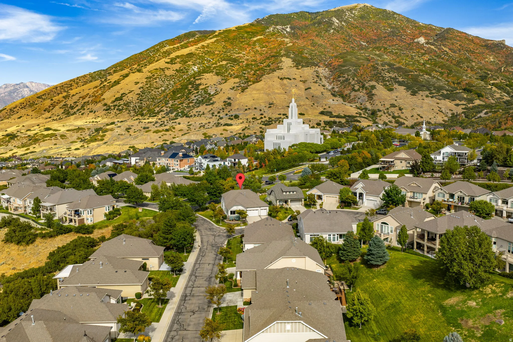 Aerial view of property's location with nearby suburban area and mountains