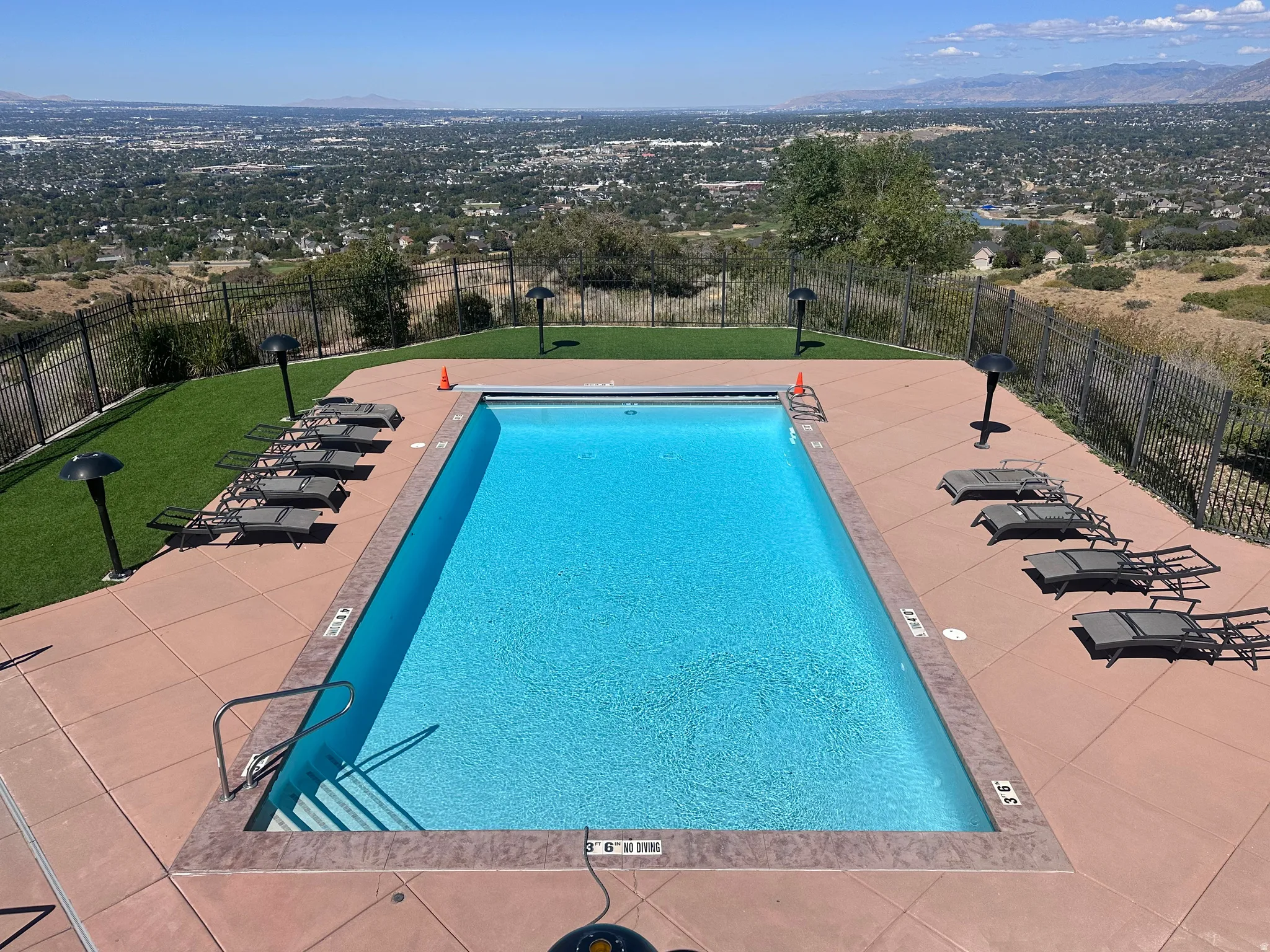 Community pool with a mountain view and a patio area