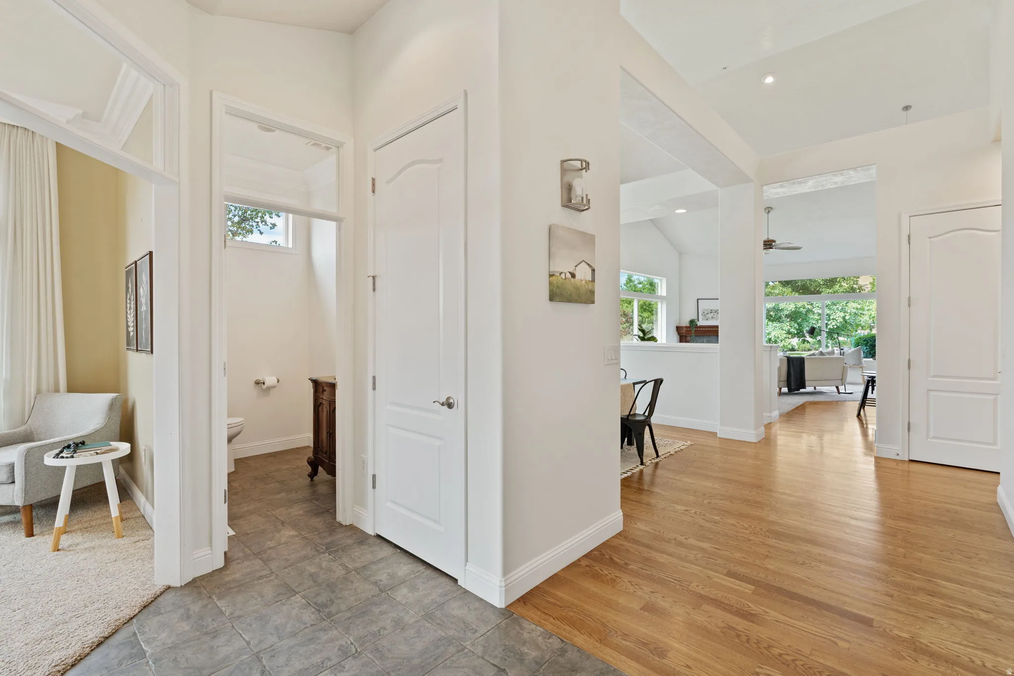 Hallway featuring plenty of natural light, light wood-style floors, and recessed lighting