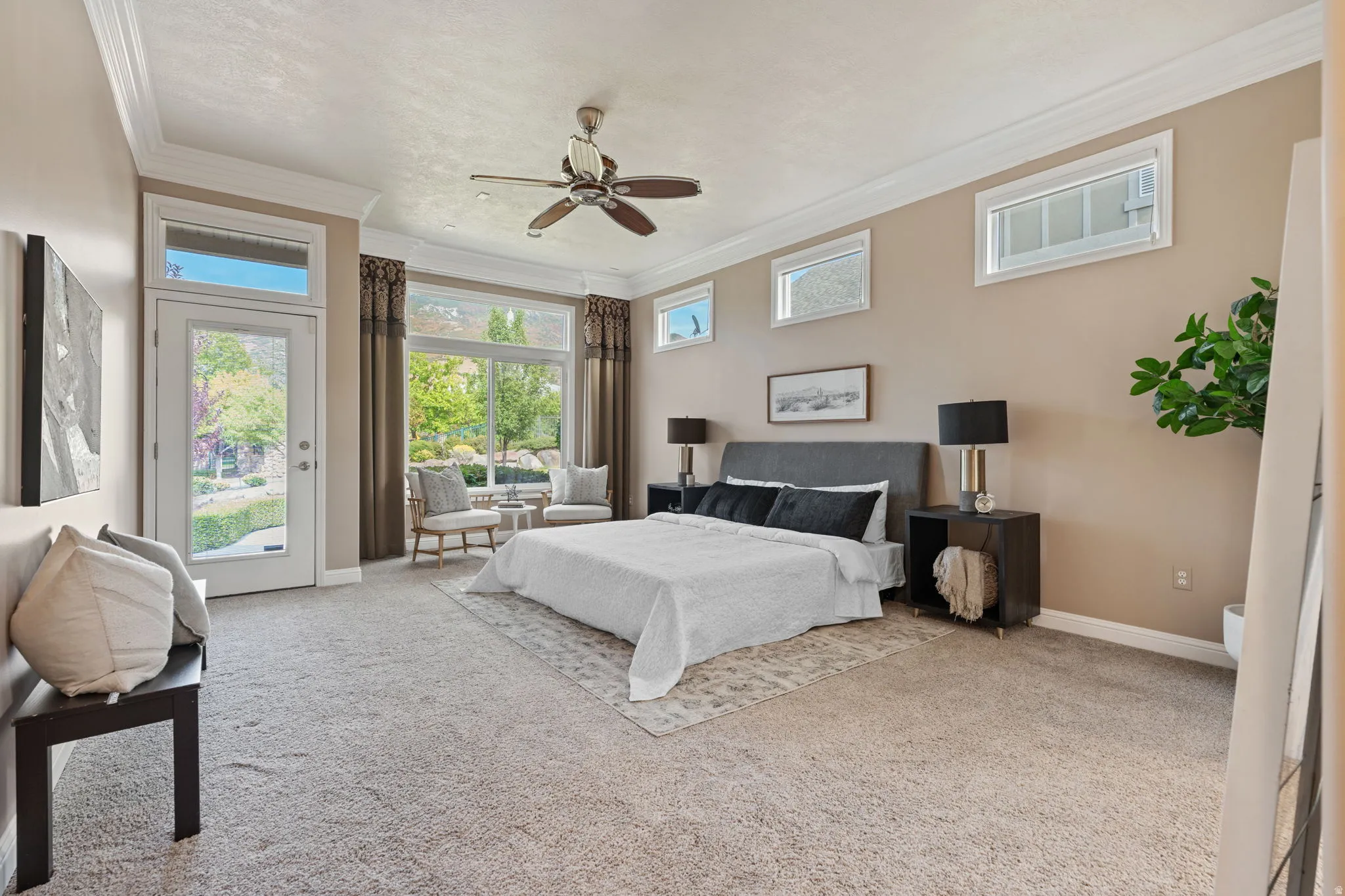 Master bedroom featuring access to exterior, carpet floors, crown molding, and ceiling fan