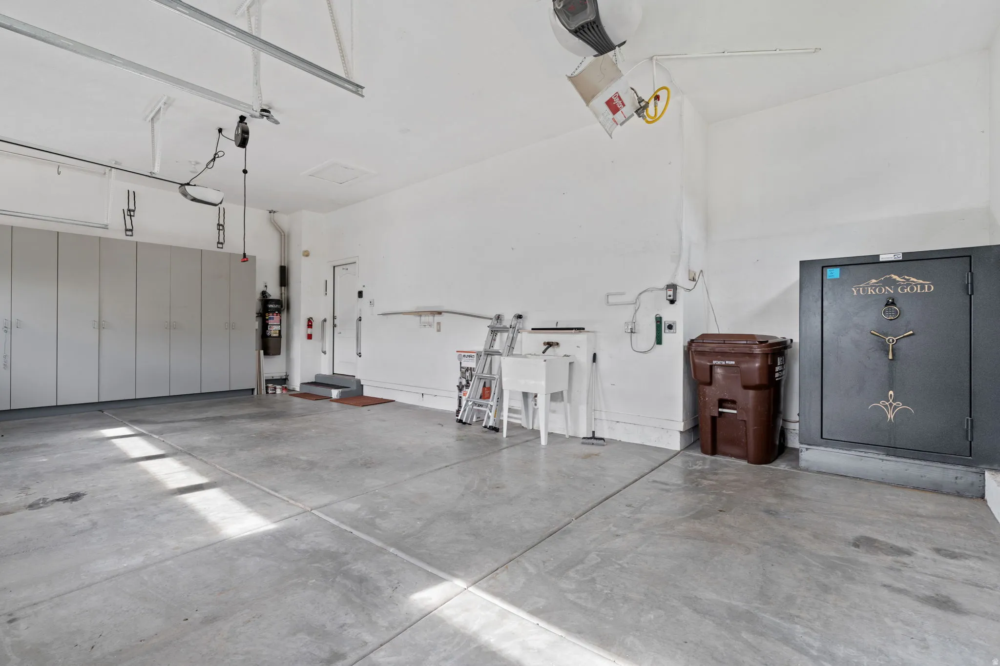 Garage with a garage door opener and a sink