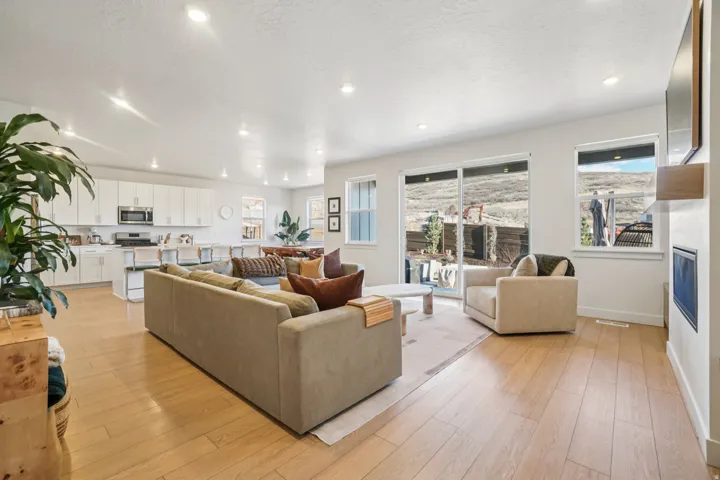 Living area featuring light wood-style flooring, recessed lighting, and a textured ceiling