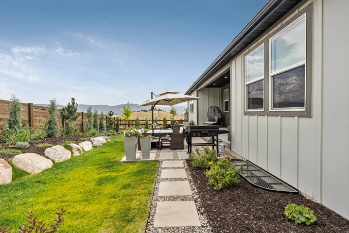 Fenced backyard with a patio area, outdoor lounge area, and a mountain view