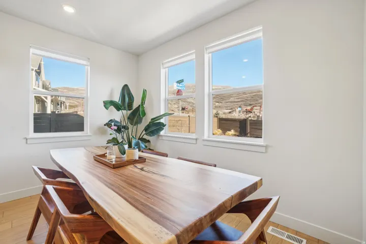 Dining space featuring light wood finished floors and recessed lighting