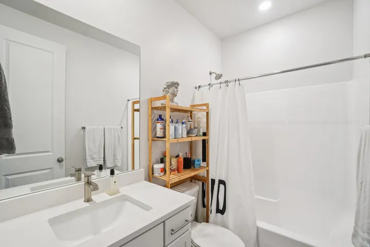 Full bathroom with shower / tub combo and vanity