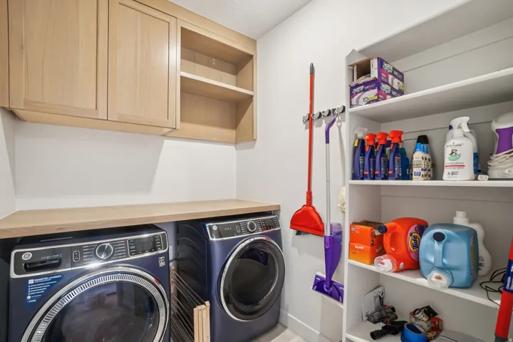 Laundry area with independent washer and dryer and cabinet space