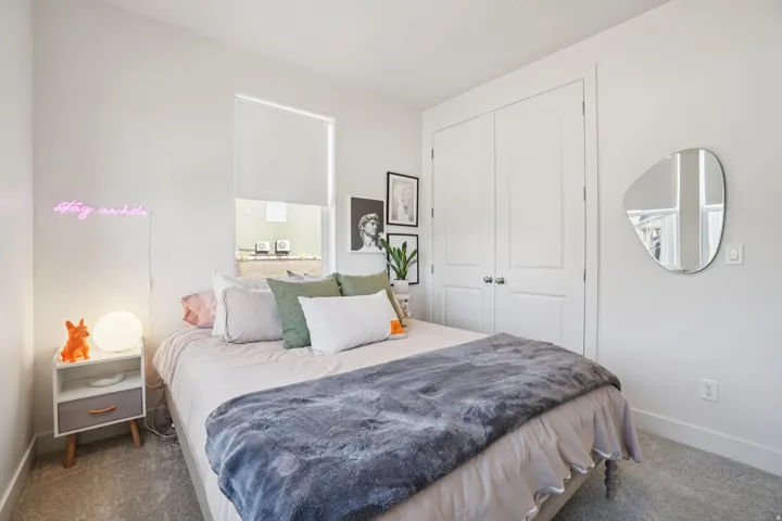 Carpeted bedroom with baseboards and a closet