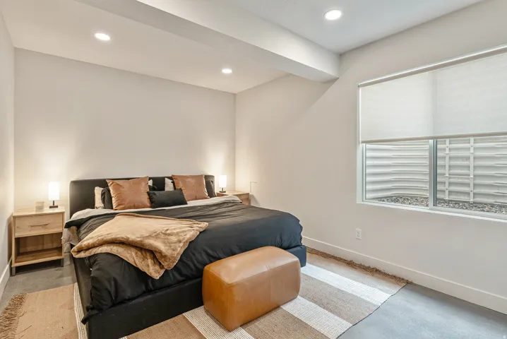 Carpeted bedroom with baseboards and recessed lighting