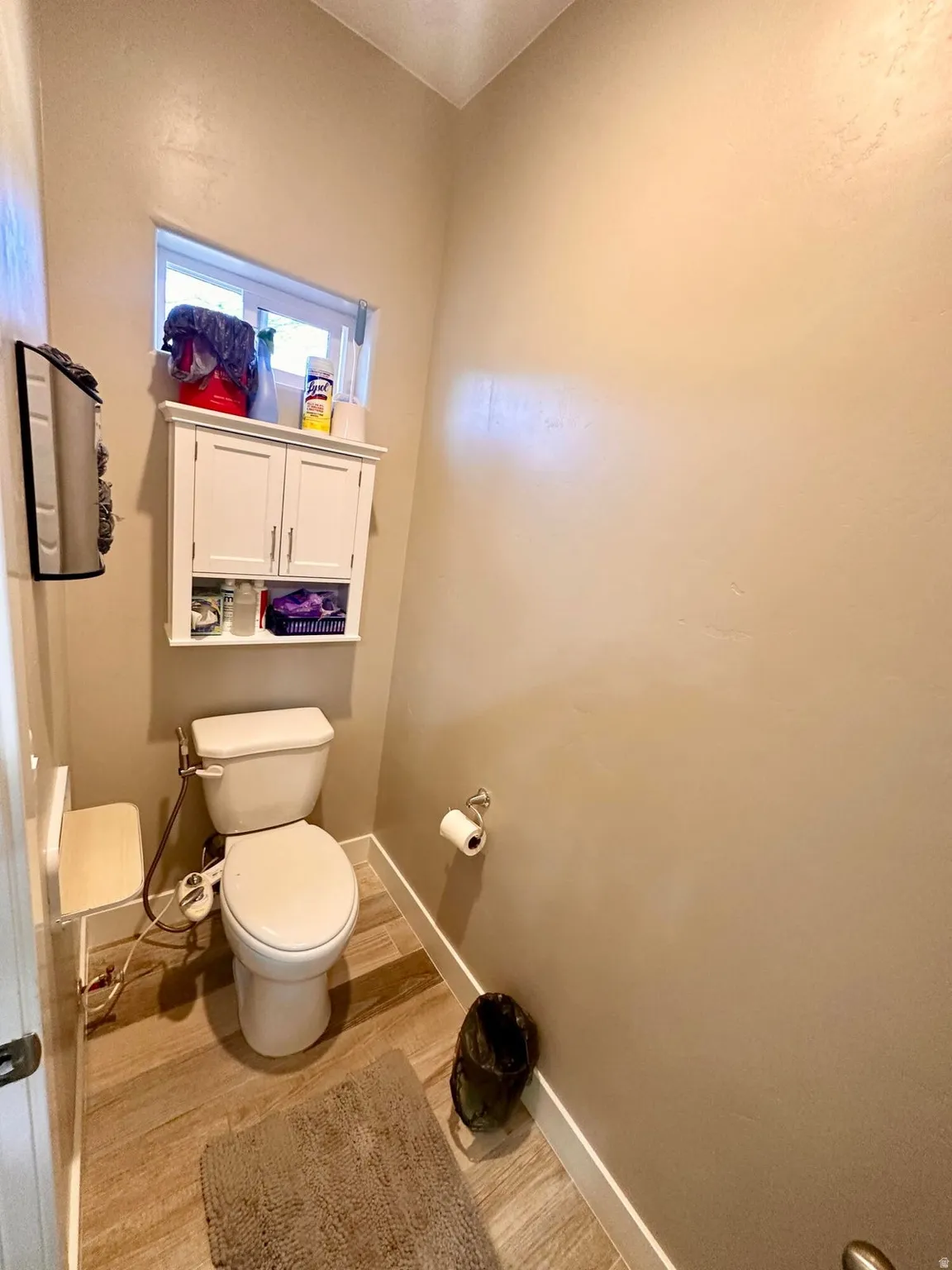 Bathroom featuring toilet and light wood-type flooring
