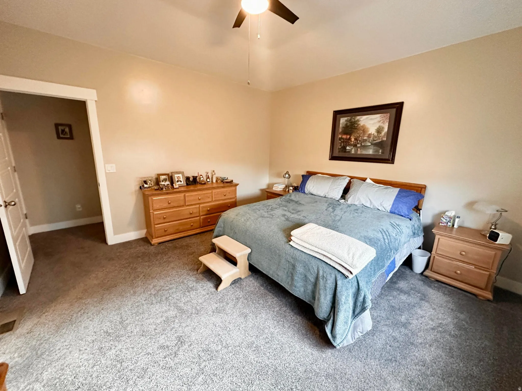 Carpeted bedroom featuring baseboards and ceiling fan