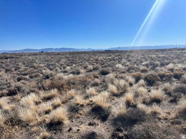View of mountain backdrop with rural landscape and a desert landscape