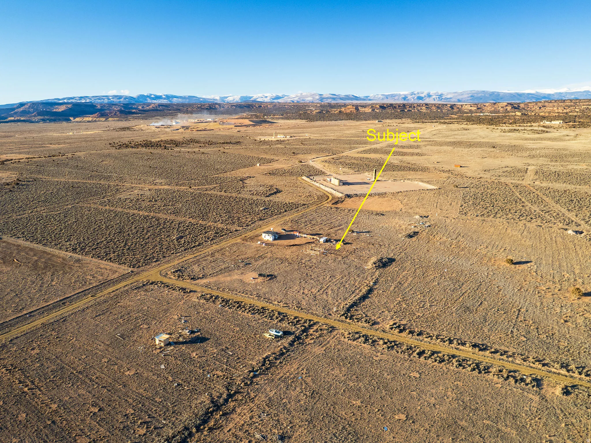 Overview of rural landscape with a desert landscape and a mountain backdrop
