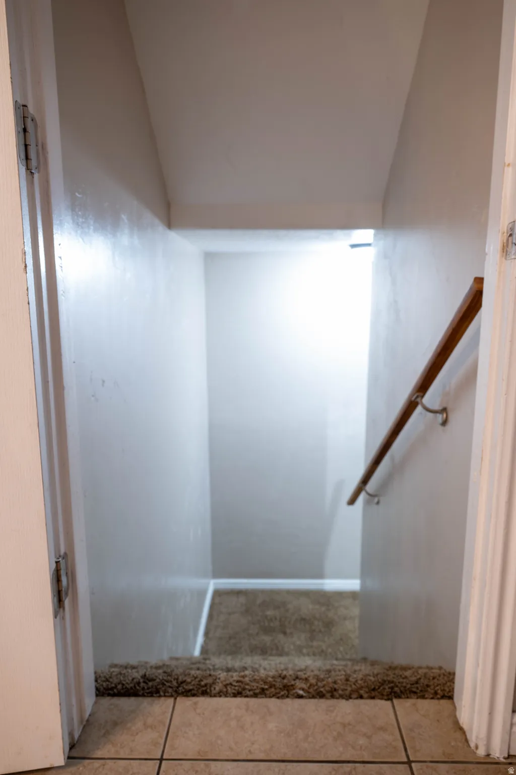 Staircase with tile patterned floors