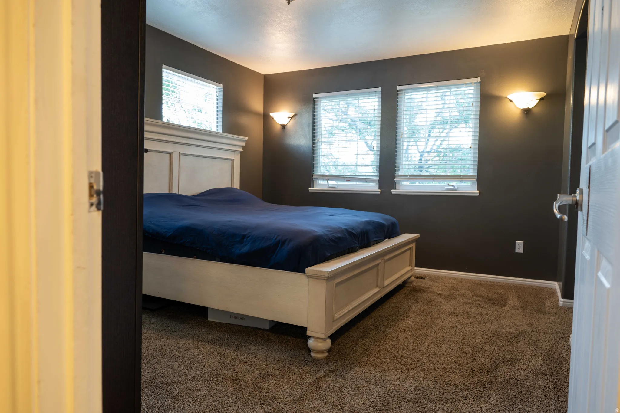 Carpeted bedroom featuring baseboards