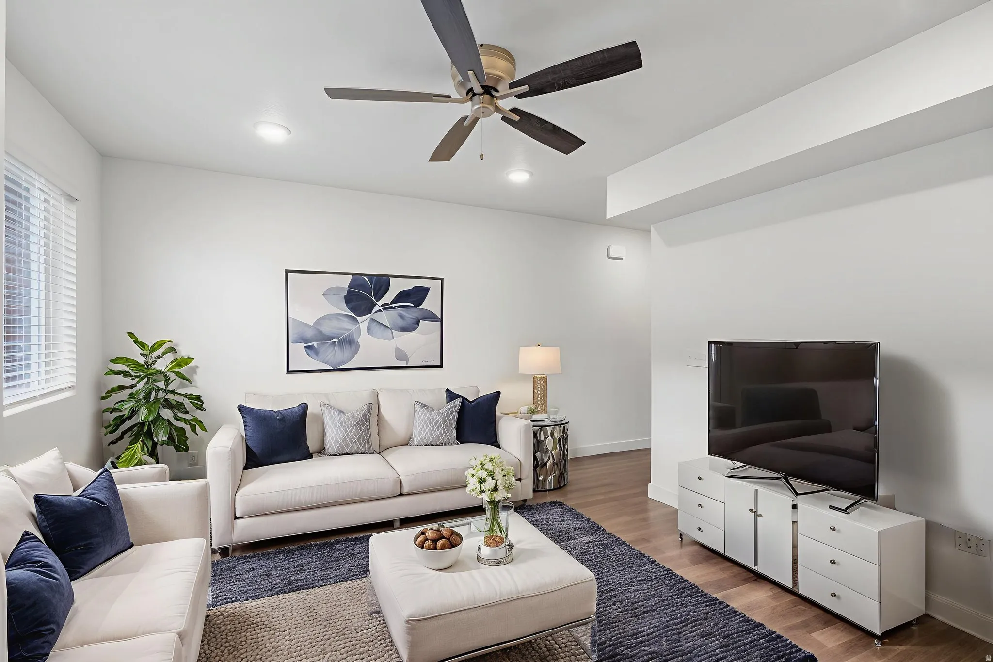 Living room featuring wood finished floors, ceiling fan, and recessed lighting