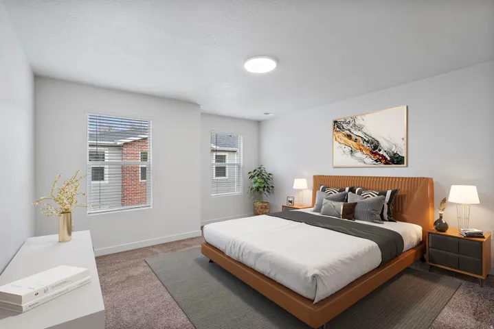 Carpeted bedroom featuring baseboards and a textured ceiling