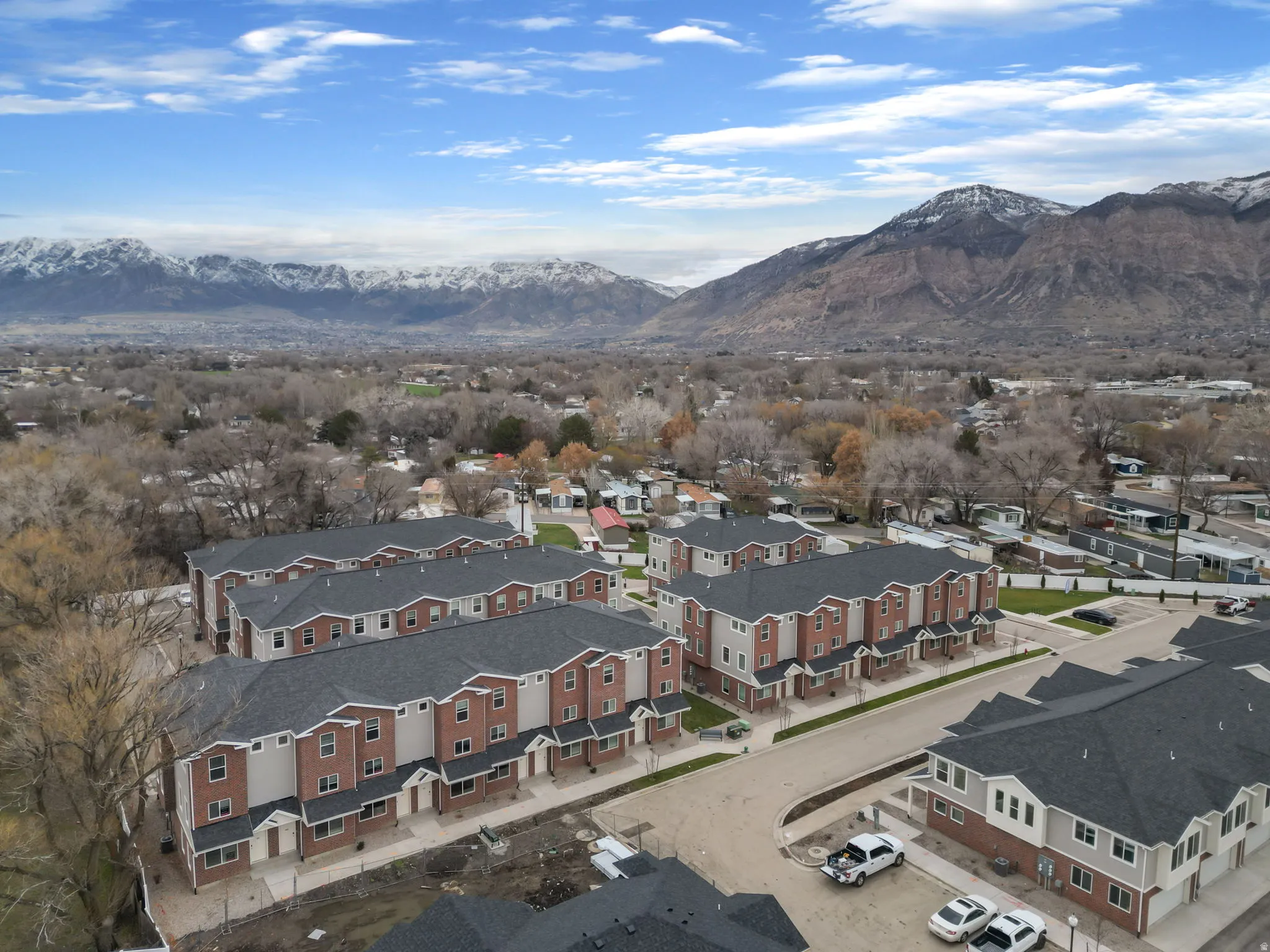 Aerial view of property's location with a mountain backdrop and nearby suburban area