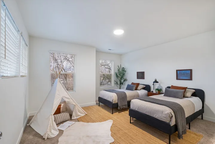 Carpeted bedroom featuring baseboards