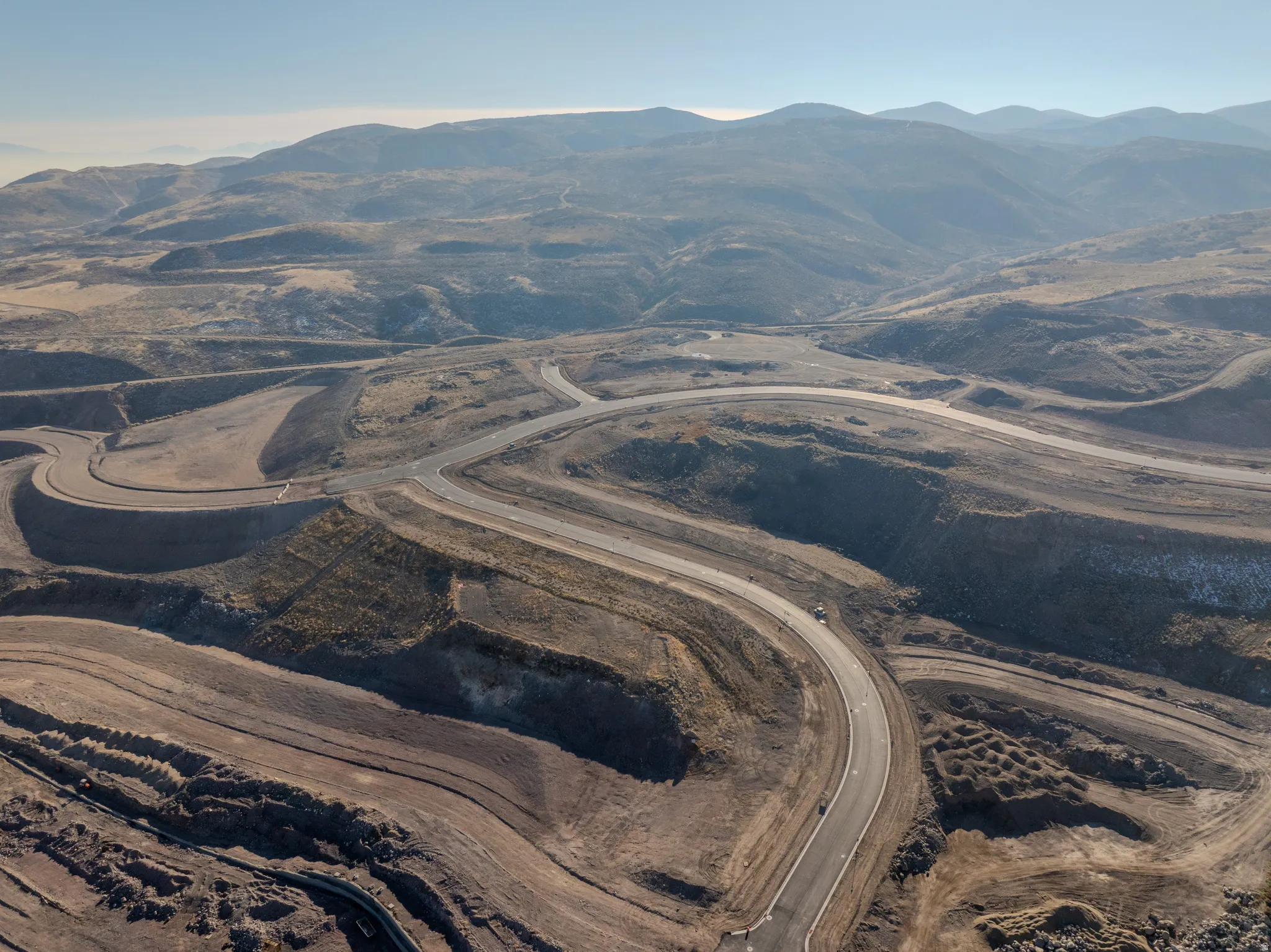 Aerial view of property and surrounding area with a mountain backdrop