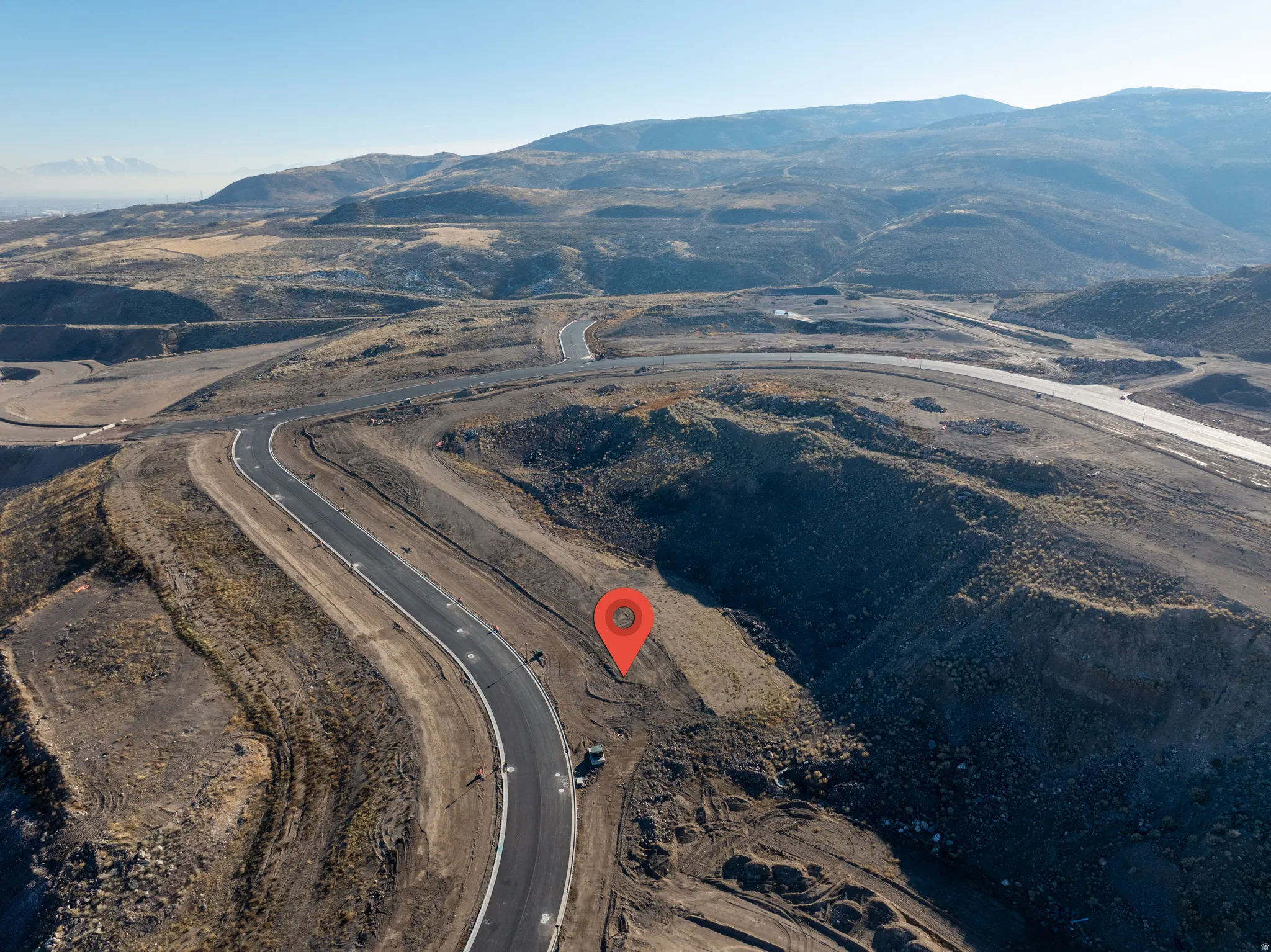 Aerial overview of property's location featuring a mountainous background