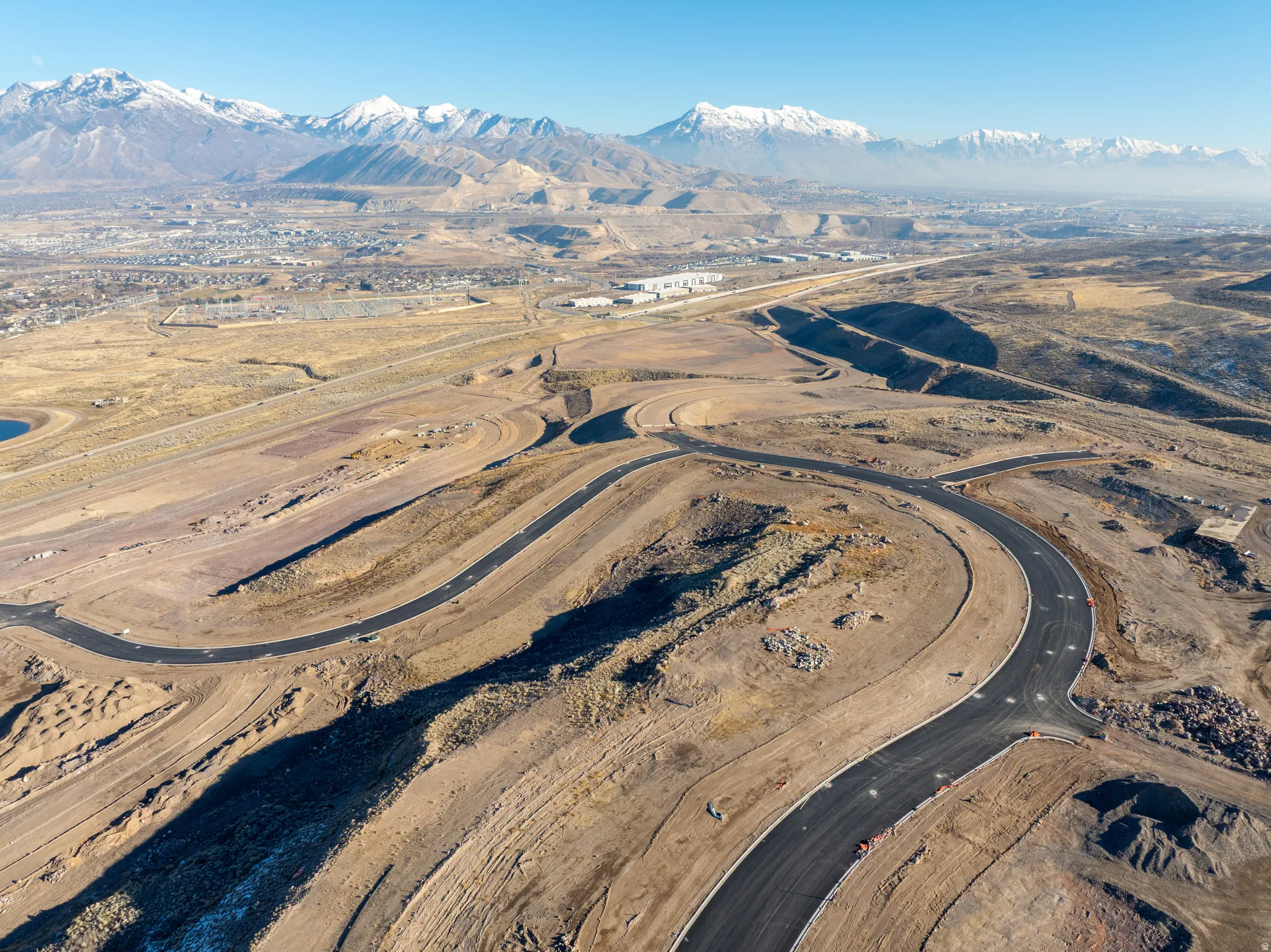 Aerial overview of property's location with a mountainous background and rural landscape