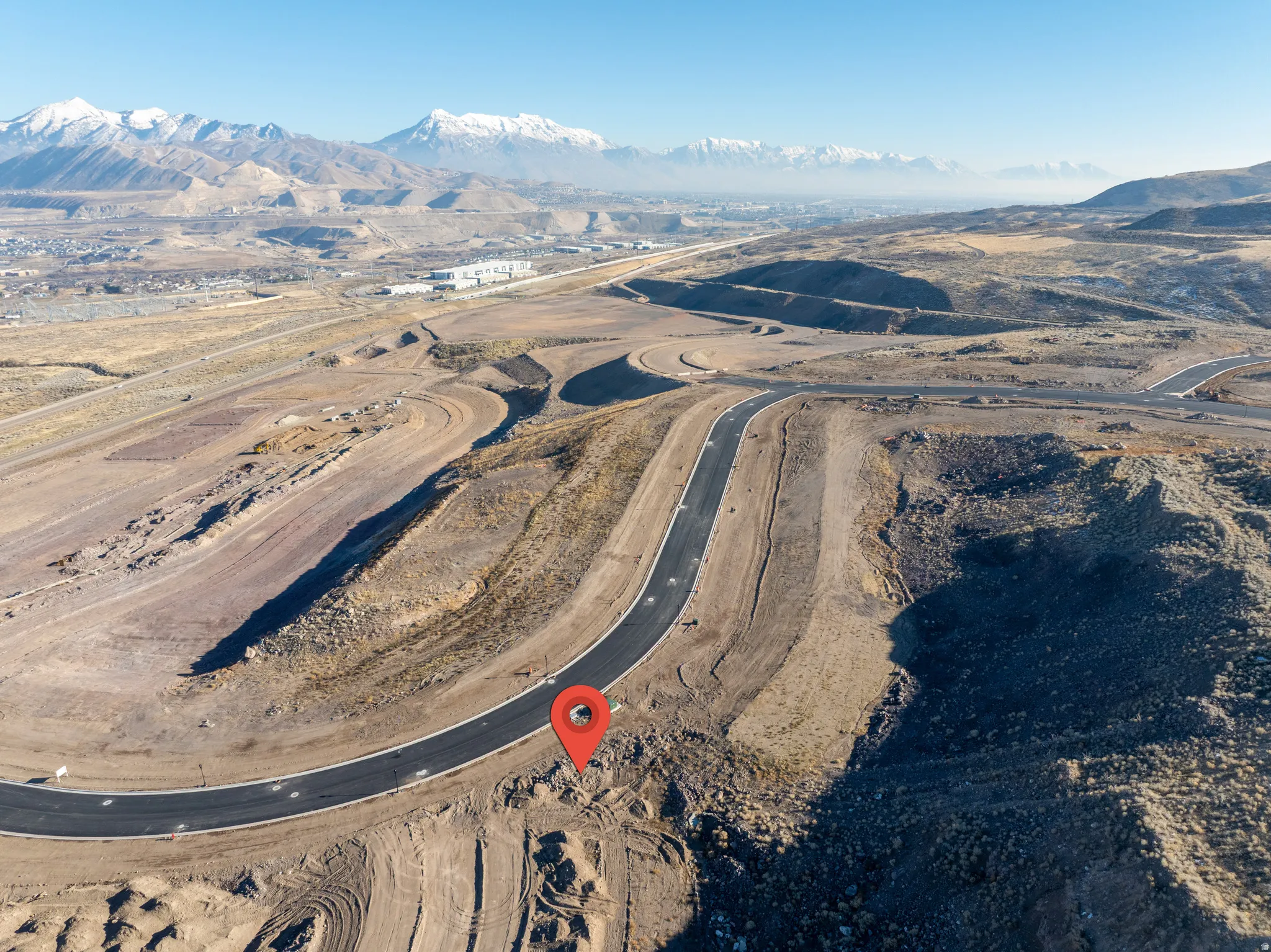 Aerial view of property and surrounding area with a mountainous background
