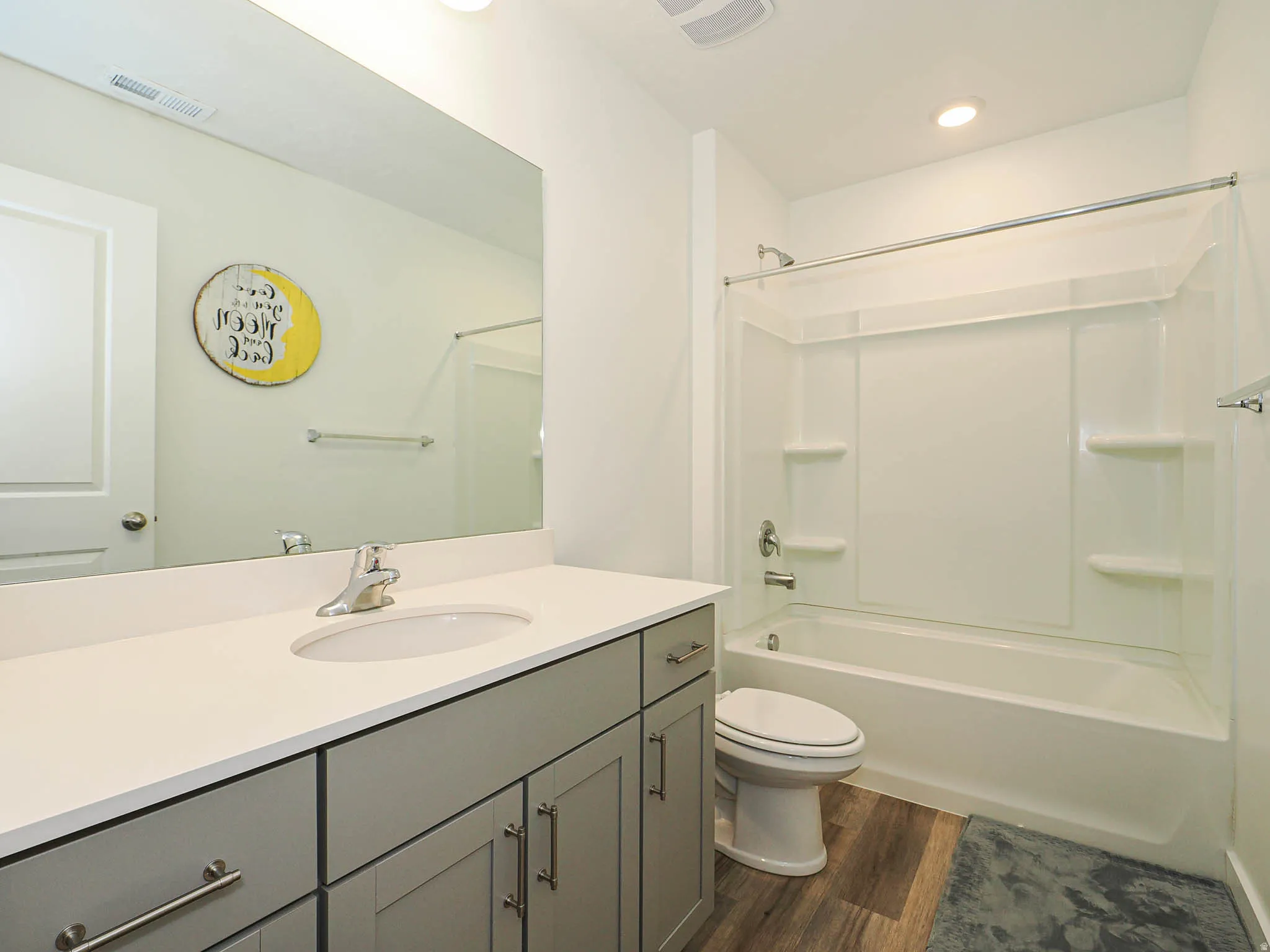 Full bathroom featuring bathing tub / shower combination, vanity, dark wood-type flooring, and recessed lighting