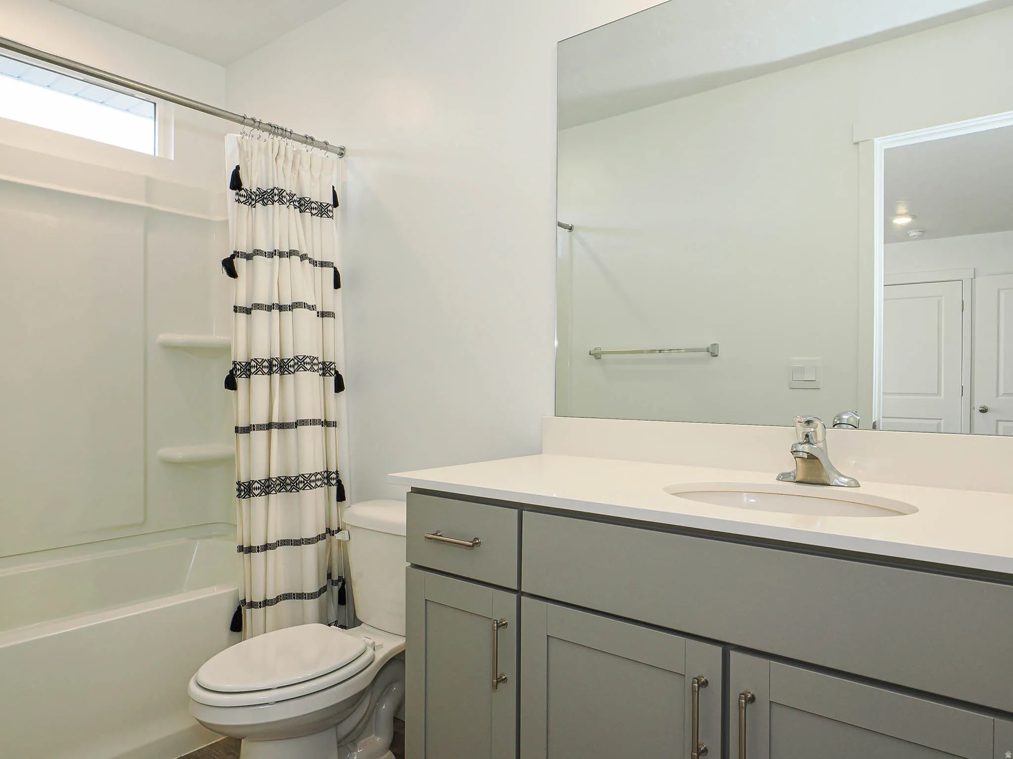 Full bathroom featuring shower / bathtub combination with curtain and vanity