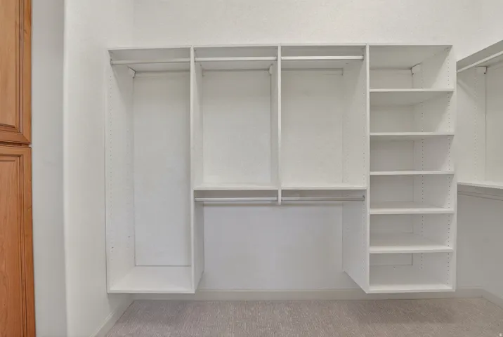 Custom closet system featuring white shelving units