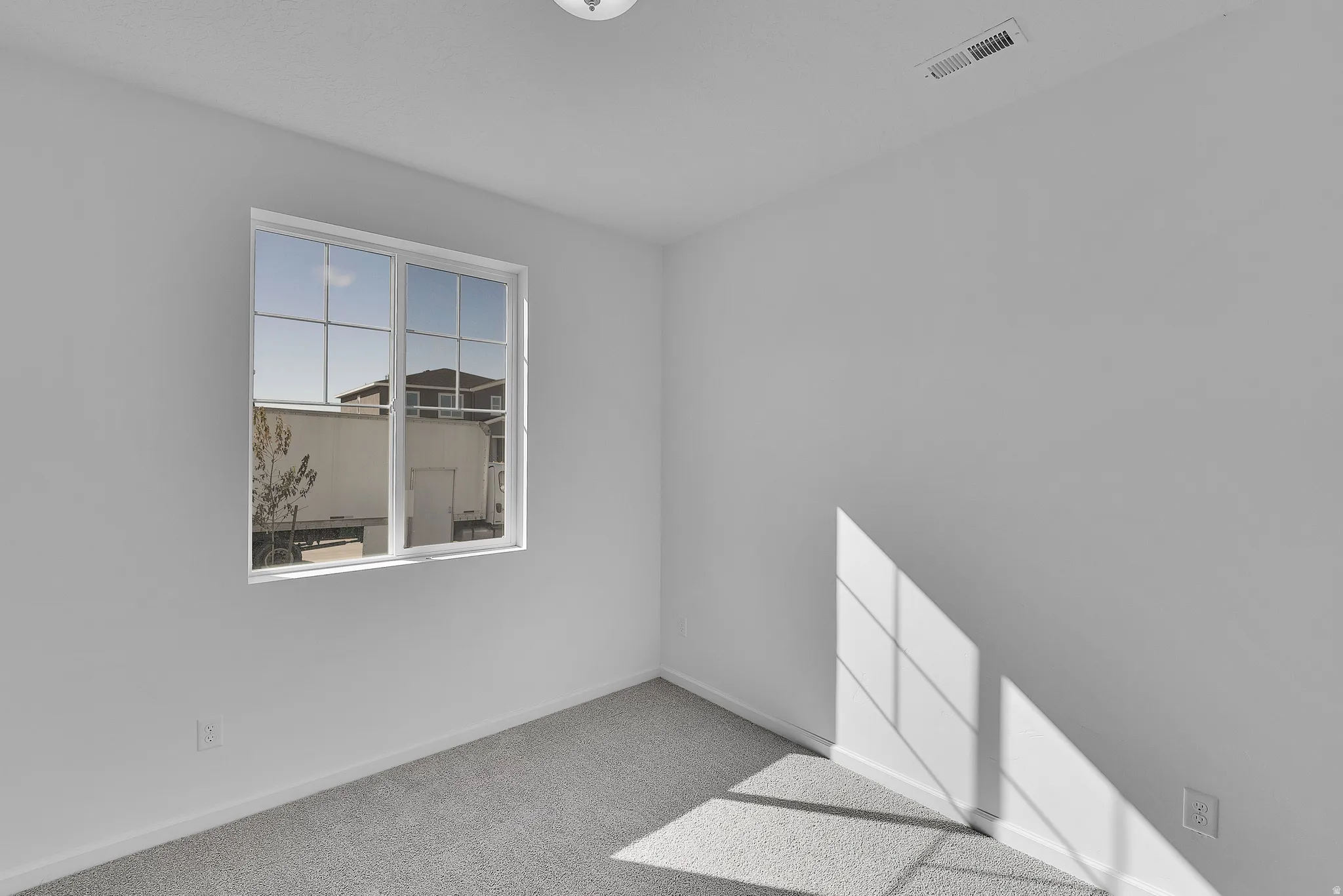 Spare room with carpet flooring and baseboards