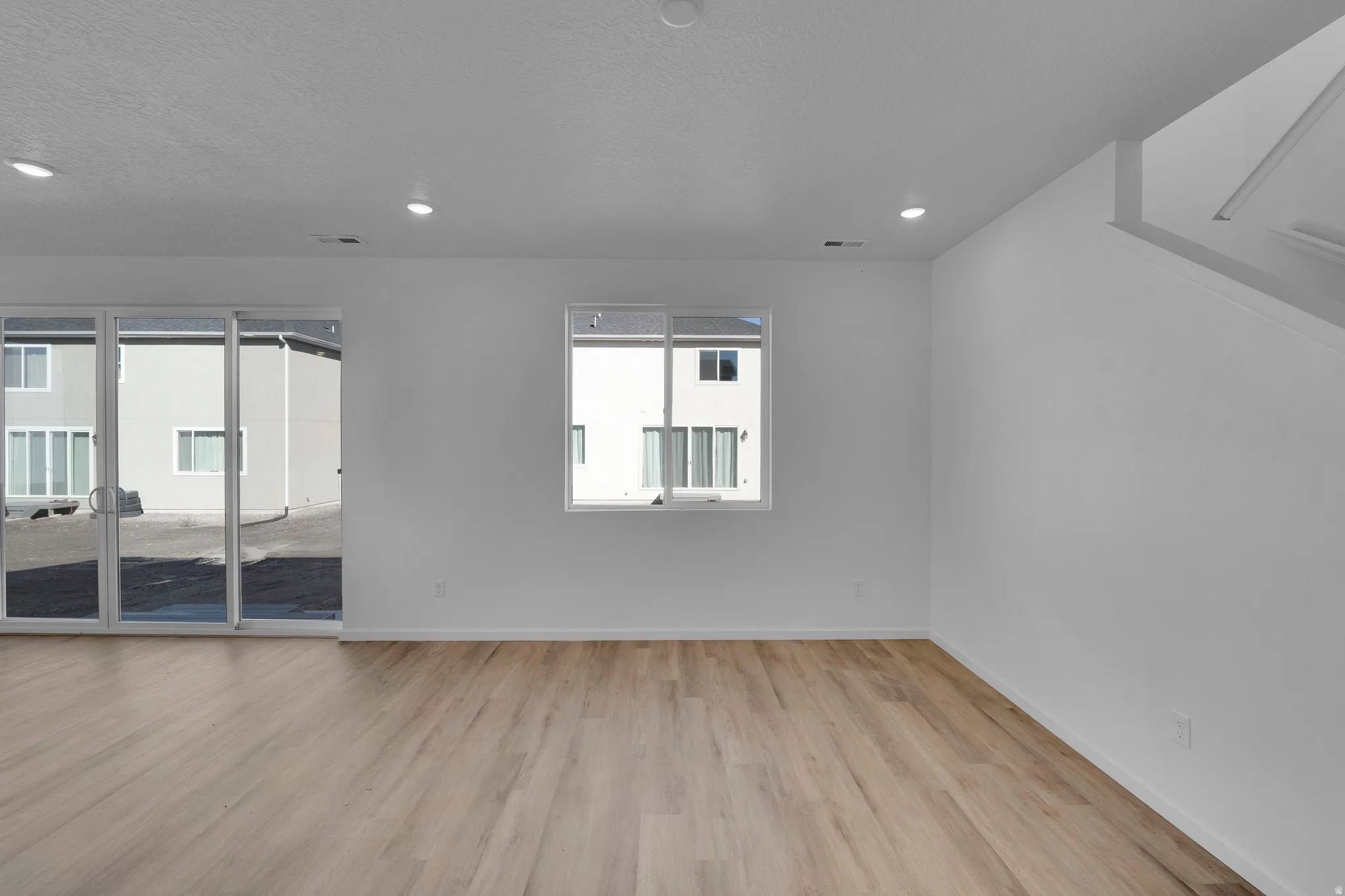 Spare room with light wood-type flooring and recessed lighting