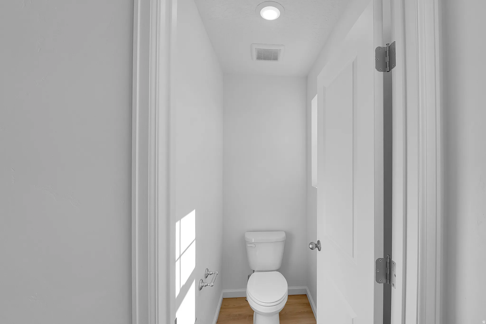 Bathroom with toilet and light wood-type flooring