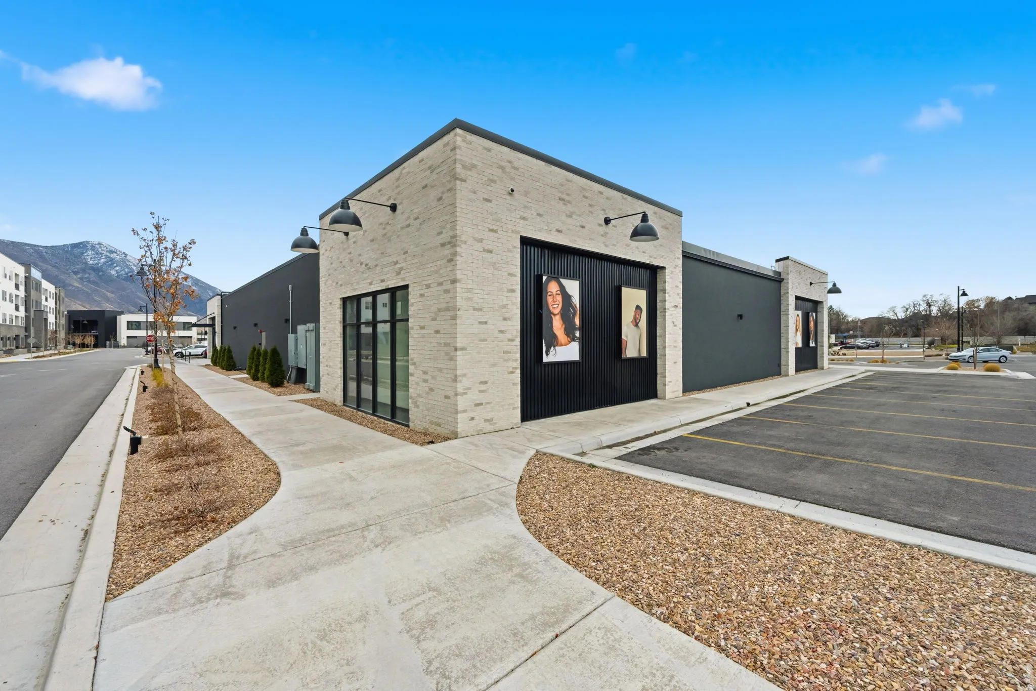 View of building exterior featuring uncovered parking