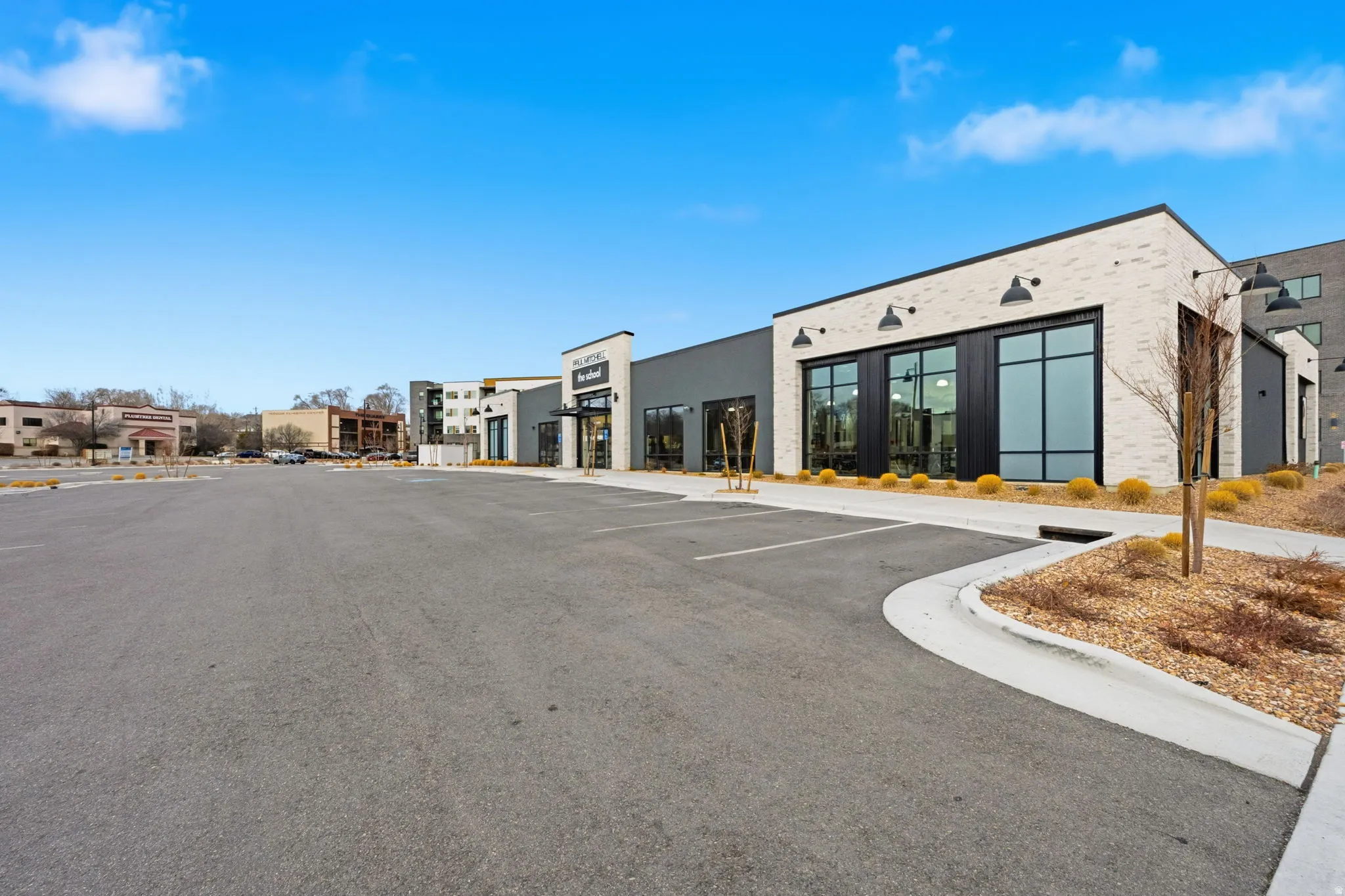 View of commercial property with uncovered parking