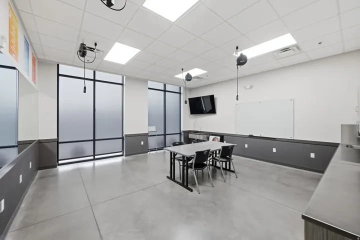 Dining space with a paneled ceiling and concrete floors