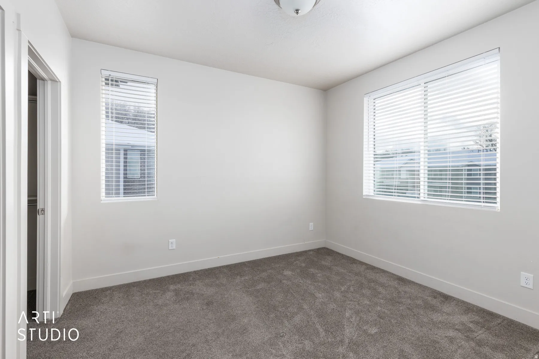 Unfurnished bedroom with carpet floors and baseboards
